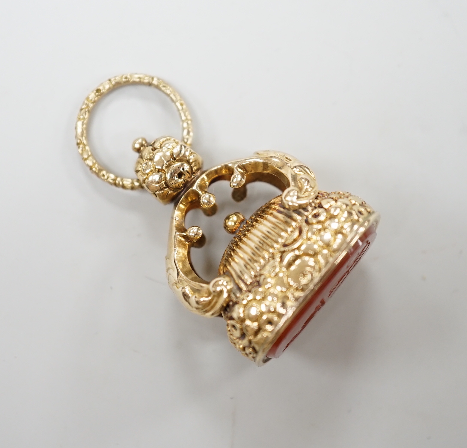 A 19th century yellow metal overlaid and carnelian set fob seal, the matrix carved with crest and monogram, 37mm.